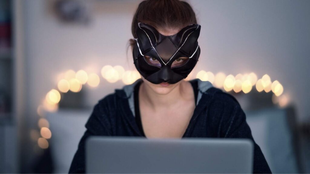 Young female faceless webcam model in cat mask